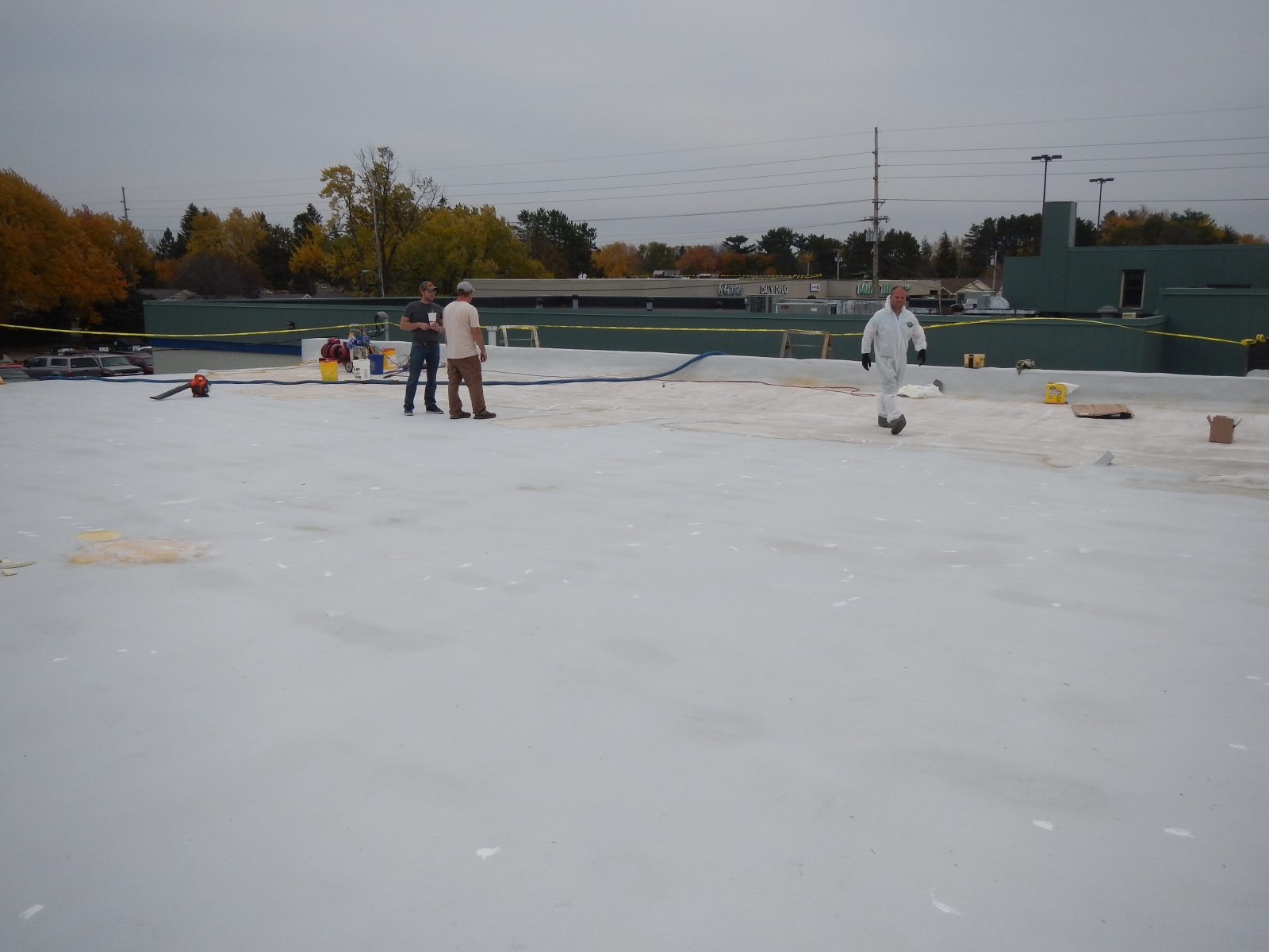 Metal roof panel laps primed before membrane application